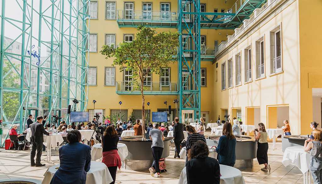Courtyard with bar tables and lots of people